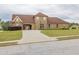 Wide view of an expansive lawn featuring a two-car garage and a basketball hoop for recreational activity at 401 Sara Ct, Loganville, GA 30052
