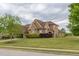 A brick house with green bushes around it is located on a large grassy lot at 401 Sara Ct, Loganville, GA 30052