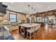 Open kitchen and living room featuring a large island, stainless steel appliances, and hardwood floors at 401 Sara Ct, Loganville, GA 30052