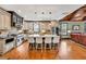 Spacious kitchen with stainless appliances, a large center island, and hardwood floors adjoining the living room at 401 Sara Ct, Loganville, GA 30052