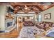 Cozy living room with hardwood floors, stone fireplace, comfortable seating, and ample natural light at 401 Sara Ct, Loganville, GA 30052