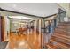 Open-concept living space featuring hardwood floors, kitchen view, dining area, and elegant staircase at 401 Sara Ct, Loganville, GA 30052