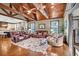 Bright living room with hardwood floors, exposed beams, comfortable seating, and open layout at 401 Sara Ct, Loganville, GA 30052
