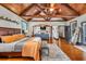 Bright and spacious main bedroom with vaulted wood beams and a cozy sitting area at 401 Sara Ct, Loganville, GA 30052