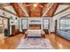 Comfortable main bedroom featuring wood beams, a ceiling fan, and ample natural light at 401 Sara Ct, Loganville, GA 30052