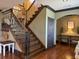 Elegant staircase showcasing dark wood steps, iron railings, and detailed trim work at 401 Sara Ct, Loganville, GA 30052