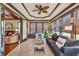 Bright sunroom with tile flooring, large windows, comfortable seating, and lots of natural light at 401 Sara Ct, Loganville, GA 30052