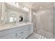 Bathroom with double vanity, large mirror, and a glass-enclosed shower at 6304 Brookwater Vw, Mableton, GA 30126
