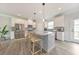 Modern kitchen with stainless steel appliances, an island with seating, and ample natural light from a window at 6304 Brookwater Vw, Mableton, GA 30126