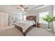 Spacious bedroom with a tray ceiling, a ceiling fan, and bright windows at 6304 Brookwater Vw, Mableton, GA 30126