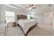 Bright main bedroom with tray ceiling, fan, large window, and desk at 6304 Brookwater Vw, Mableton, GA 30126