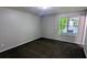 Cozy bedroom with soft carpet, neutral paint, and a bright window overlooking the outdoors at 685 Greenhedge Dr, Stone Mountain, GA 30088