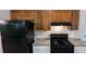 Efficient kitchen layout with dark appliances, wood cabinets, and granite countertops at 685 Greenhedge Dr, Stone Mountain, GA 30088