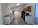 Functional kitchen with white cabinets, modern appliances, and view into the dining room at 685 Greenhedge Dr, Stone Mountain, GA 30088
