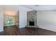Inviting living room features a stone fireplace and stylish dark wood floors at 685 Greenhedge Dr, Stone Mountain, GA 30088