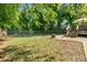 Large backyard with a wooden fence, a fire pit, and a deck with stairs, perfect for outdoor activities at 1659 Beecher Sw St, Atlanta, GA 30310