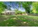 Expansive backyard featuring a well-maintained lawn, mature trees, and a charming deck at 1659 Beecher Sw St, Atlanta, GA 30310