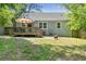 Home exterior features a deck with outdoor seating, along with a fire pit in a well-manicured yard at 1659 Beecher Sw St, Atlanta, GA 30310