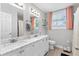 Bright bathroom featuring double sinks, marble counters, and modern fixtures at 1659 Beecher Sw St, Atlanta, GA 30310