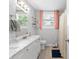 Bathroom featuring marble countertops, double vanity, wood flooring, and a shower at 1659 Beecher Sw St, Atlanta, GA 30310