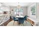 Bright breakfast nook with a stylish chandelier, round table, blue chairs and natural light at 1659 Beecher Sw St, Atlanta, GA 30310