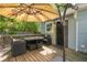 Outdoor deck featuring an umbrella, a patio table, and chairs, with a door providing access to the house at 1659 Beecher Sw St, Atlanta, GA 30310