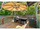 Outdoor deck features an umbrella, a patio table, and chairs set perfect for outdoor dining and relaxation at 1659 Beecher Sw St, Atlanta, GA 30310