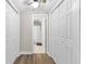 Bright hallway featuring hardwood floors, with closet doors and bathroom in the background at 1659 Beecher Sw St, Atlanta, GA 30310