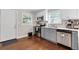 Kitchen showcasing stainless steel appliances, gray and white cabinets, and hardwood flooring at 1659 Beecher Sw St, Atlanta, GA 30310