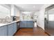 The kitchen features gray cabinets, marble counter tops and stainless steel appliances at 1659 Beecher Sw St, Atlanta, GA 30310