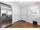 Spacious kitchen featuring stainless refrigerator, hardwood floors, and convenient pantry at 1659 Beecher Sw St, Atlanta, GA 30310