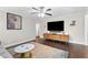 Stylish living room featuring hardwood floors, a modern entertainment center, and a comfortable seating area at 1659 Beecher Sw St, Atlanta, GA 30310