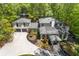Aerial view of a home surrounded by lush greenery and a long driveway at 4067 Randall Farm Se Rd, Atlanta, GA 30339