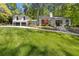 View of a beautiful home with lush green lawn and mature trees at 4067 Randall Farm Se Rd, Atlanta, GA 30339