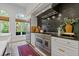 Gourmet kitchen with modern appliances, stone backsplash, and ample counter space at 4067 Randall Farm Se Rd, Atlanta, GA 30339