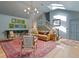 Bright living room with an open staircase, skylight, hardwood floors, and a stylish area rug at 4067 Randall Farm Se Rd, Atlanta, GA 30339