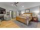 Spacious main bedroom features a sitting area with fireplace, hardwood floors, and stylish decor at 4067 Randall Farm Se Rd, Atlanta, GA 30339