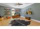 Stylish home office features hardwood floors, built in shelves, and a ceiling fan at 4067 Randall Farm Se Rd, Atlanta, GA 30339