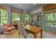 Well-lit office featuring a custom desk, built-in bookshelves, and large windows overlooking a lush, green landscape at 4067 Randall Farm Se Rd, Atlanta, GA 30339
