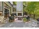 Inviting outdoor patio with fireplace, comfortable seating, and lush green surroundings for relaxation at 4067 Randall Farm Se Rd, Atlanta, GA 30339