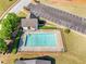 Aerial view of community pool with parking, clubhouse, and meticulously manicured landscaping at 823 Langley View Ct, Loganville, GA 30052