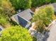 Aerial shot of well-maintained home featuring a dark roof, established trees, and an attached garage at 823 Langley View Ct, Loganville, GA 30052