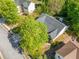 Aerial view of home with mature trees, well-kept lawn, and close proximity to other homes at 823 Langley View Ct, Loganville, GA 30052