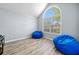 Bright bedroom with large arched window and two comfortable beanbag chairs at 823 Langley View Ct, Loganville, GA 30052