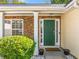 Inviting front entrance with a green door, stone accents, and neatly trimmed bushes at 823 Langley View Ct, Loganville, GA 30052