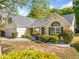 Well-maintained single-Gathering home with lush landscaping and a cozy, inviting front entrance at 823 Langley View Ct, Loganville, GA 30052
