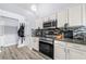 Modern kitchen features stainless steel appliances and granite countertops at 823 Langley View Ct, Loganville, GA 30052