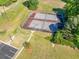 Aerial view of community tennis courts with adjacent parking, landscaping and lush greenery at 823 Langley View Ct, Loganville, GA 30052