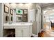 Bathroom vanity with drawers and cabinets, makeup area, natural light, and tiled shower in background at 11060 Pennbrooke Xing, Johns Creek, GA 30097