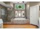 Bright bathroom with a large soaking tub, separate glass shower, and beautiful tile accents at 11060 Pennbrooke Xing, Johns Creek, GA 30097